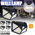 Solar outdoor wall light with 100 LEDs illuminating a garden patio at dusk